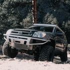 V8 4Runner climbing a mountain trail and equipped with a C4 winch bumper.