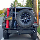 4Runner parked along a city street and equipped with a C4 Fabrications steel rear bumper with dual swing-outs for spare tire, high-lift jack, MaxTrax, RotoPax and a relocated license plate.