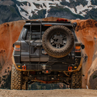 Grey 4Runner equipped with the C4 Fabrications hatch ladder and rear bumper with half-width spare tire swing-out. 
