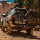 Grey 4Runner with the C4 Overland Rear Bumper installed with half-width single swing-out for its spare tire.