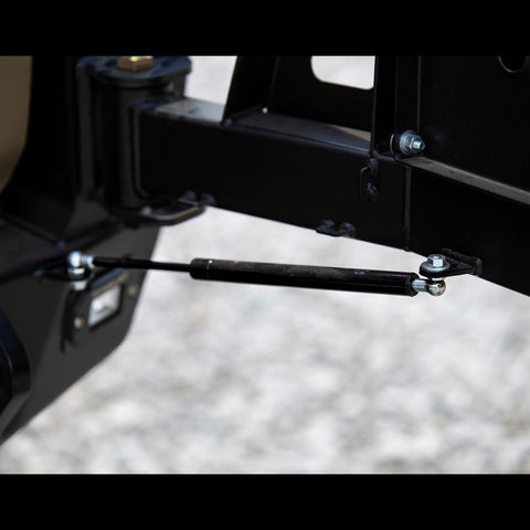 Close-up view showing the gas strut on the C4 swing-out bumper.