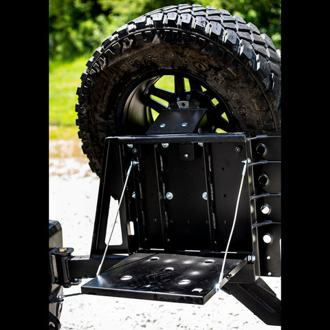 Close-up view of the fold-down table integrated into the tire-side swing of the C4 fabricated rear bumper for the Toyota 4Runner.