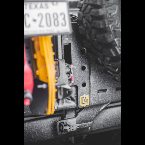Ice-encrusted view of the dual closures used on C4 Fabrication's dual swing rear bumper, with a 90-degree latch on top and the all-aluminum tension latch on the bottom. 