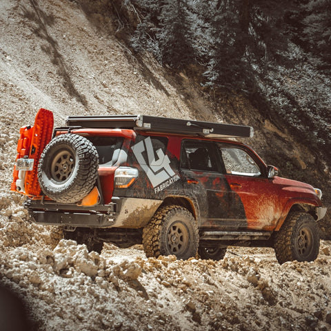 Maroon 4Runner with Rooftop Tent, sliders and the C4 Fabrications rear bumper with tire swingout. 