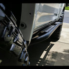 Looking from front to rear down the side of a white 4Runner equipped with a set of C4 Fabrications rock sliders.
