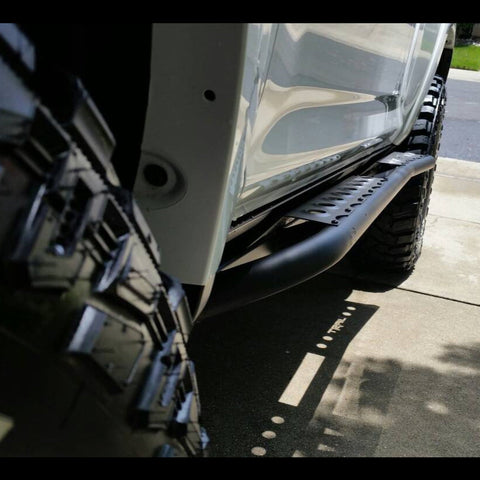 Looking from front to rear down the side of a white 4Runner equipped with a set of C4 Fabrications rock sliders.