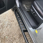Drivers door-open view of the optional side step for the 4Runner rock sliders made by C4 in Sturgis, SD.
