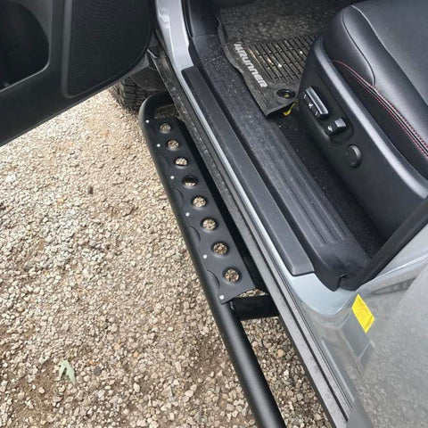 Drivers door-open view of the optional side step for the 4Runner rock sliders made by C4 in Sturgis, SD.