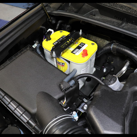 A view looking into the rear passenger side of a 4Runner engine bay where an Optima Yellow Top battery is installed using a C4 Fabrications Spare Battery Tray.