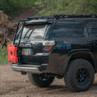 Black 4Runner with oversized tires, roof rack and C4 Summit hatch ladder.