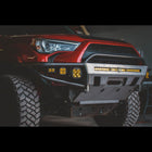 Shadowy photo of a red 4Runner with a C4 Hybrid bumper still in the raw metal finish that all C4 bumpers and armor ship in.
