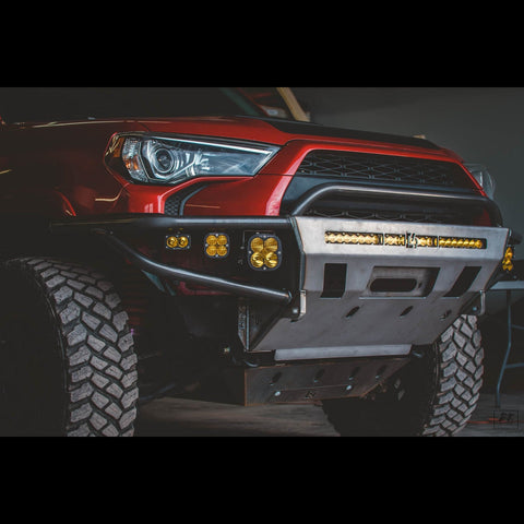 Shadowy photo of a red 4Runner with a C4 Hybrid bumper still in the raw metal finish that all C4 bumpers and armor ship in.