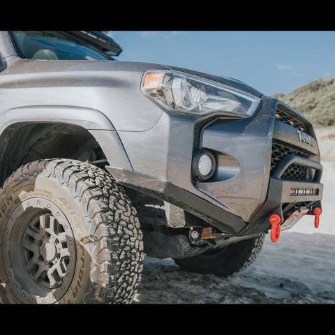 Close-up of the High Clearance Additions from C4 Fabrication on a grey 4Runner at the beach. 