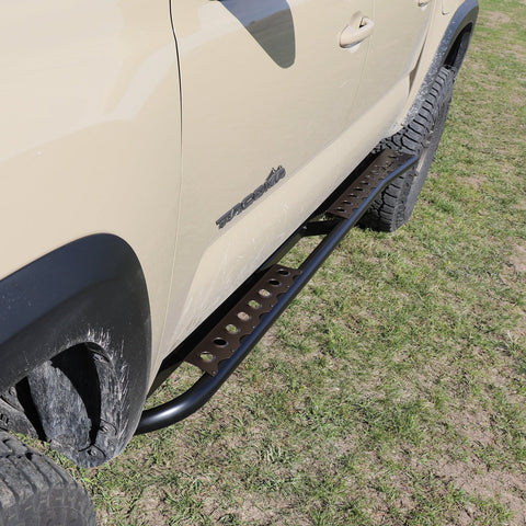 Top-down view of a set of powder coated C4 Sliders on a tan 4-door Tacoma.