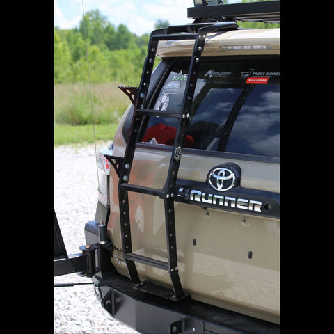 Rear view of a tan 4Runner equipped with a C4 Fabrication dual swing-out rear bumper and the Summit hatch ladder with accessory side steps. 