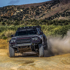 Purple wide-body Tacoma with long-travel suspension and a C4 Hybrid front winch bumper.