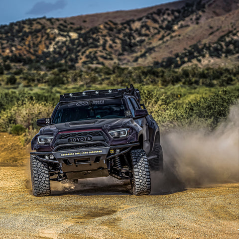 Purple wide-body Tacoma with long-travel suspension and a C4 Hybrid front winch bumper.