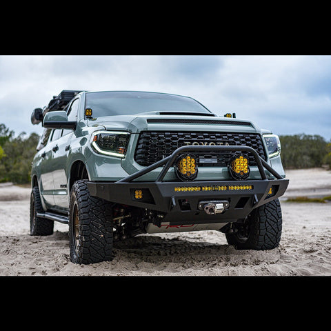 Late 2nd Generation Tundra parked on the beach with an Overland winch bumper installed.