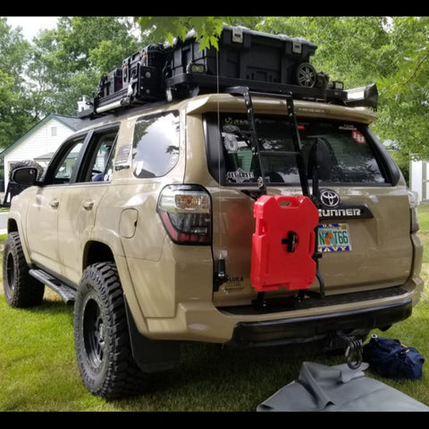 Quartering rear view of a heavily modified 4Runner with the C4 Summit Hatch Ladder with accessories attached to it.