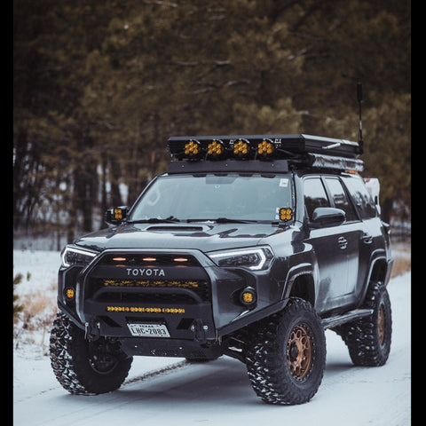 Heavily modified 4Runner in the snow showing off the front tire clearance that the C4 High Clearance Additions provide in conjunction with the Lo-Pro winch bumper. 