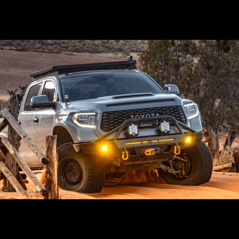 Grey Tundra driving in deep sand with a C4 Overland bumper installed.