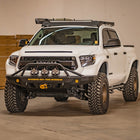 White 2014 Tundra with a C4 Fabrication Overland front winch bumper installed.
