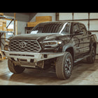 Quartering front view of the C4 Overland front winch bumper in raw steel like it ships to all customers.
