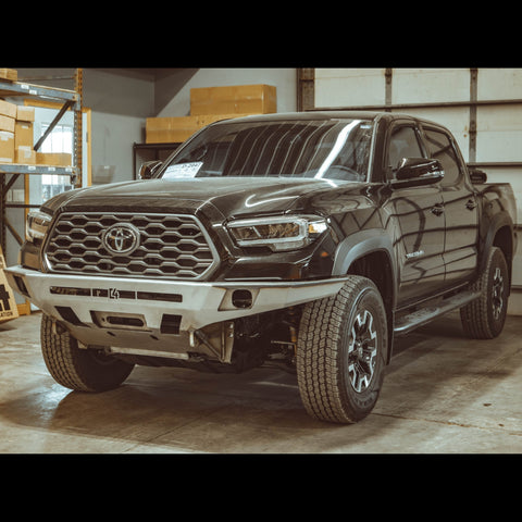 Quartering front view of the C4 Overland front winch bumper in raw steel like it ships to all customers.