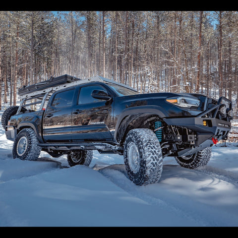 Black 3rd Gen Tacoma flexing in the snow.