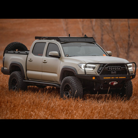 C4 Overland bumper installed on a tan 4-door Tacoma.