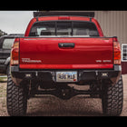 Rear view of the C4 Overland rear bumper on a red Tacoma.