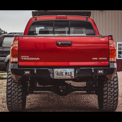 Rear view of the C4 Overland rear bumper on a red Tacoma.