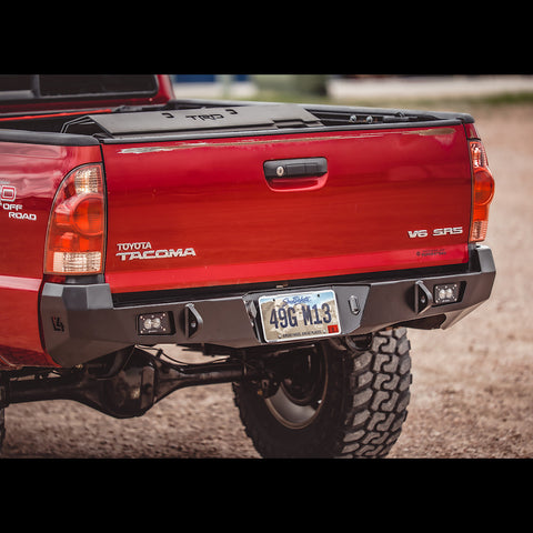 Rear view of the C4 Overland rear bumper on a red 2005+ Tacoma.