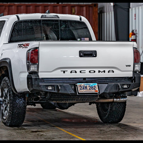 White 3rd Gen Tacoma with a C4 Overland rear bumper.