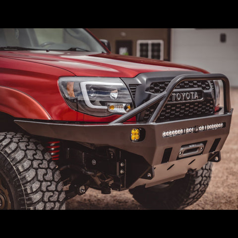Front quartering view of the C4 Overland front winch bumper with full-height bull bar and tube gussets. 