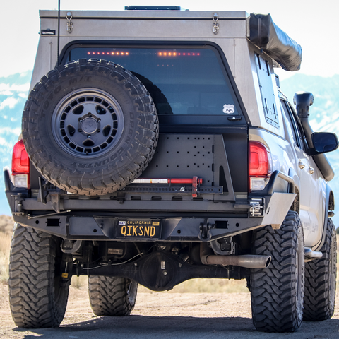 Rear view of the C4 Overland High Clearance bumper installed on a tan 3rd Gen Tacoma.