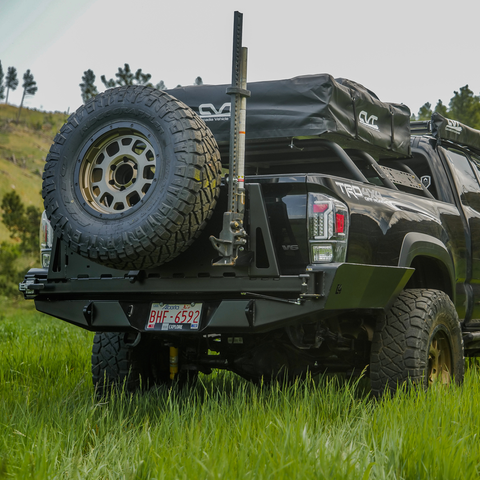Black Tacoma with the C4 swing-out high clearance bumper.
