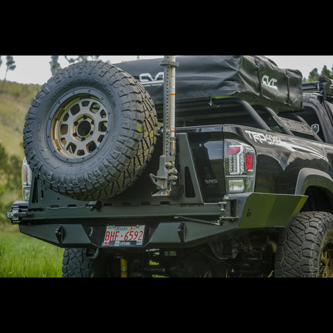 Quartering rear view of the C4 Overland High Clearance Rear Bumper with spare tire swingout, high lift jack mount and more.