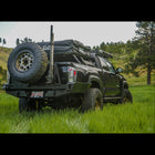Wider view of a black Tacoma with the C4 high clearance bumper with spare tire swingout.