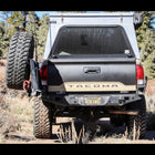 Tan Tacoma showing off the swing-out bumper system from C4 Fabrication.