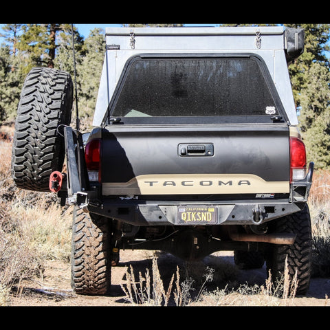 Tan Tacoma showing off the swing-out bumper system from C4 Fabrication.