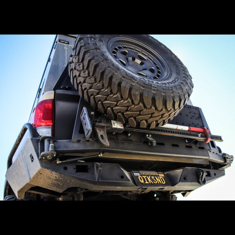 Extreme low angle view of the C4 Overland High Clearance rear bumper with spare tire swing out.