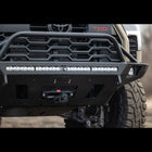Close up of the Tundra Overland bumper with mid-height bull bar and tube gussets showing off additional accessories mounted in it from a winch and light bar to side fog lights.