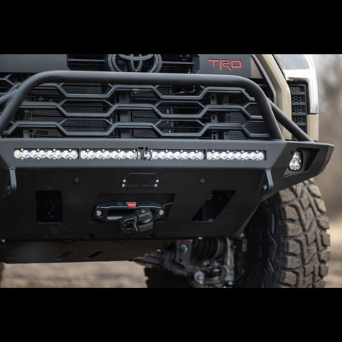 Close up of the Tundra Overland bumper with mid-height bull bar and tube gussets showing off additional accessories mounted in it from a winch and light bar to side fog lights.