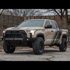Tan Toyota Tundra TRD Pro in an abandoned parking lot equipped with the Overland bumper from C4.