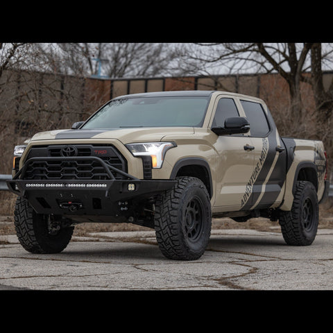 Tan Toyota Tundra TRD Pro in an abandoned parking lot equipped with the Overland bumper from C4.