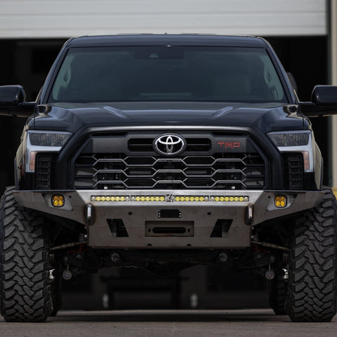 Straight-on view of a black 3rd Gen Tundra with a C4 Overland front bumper in raw steel. 