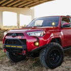 Close-up of a red 4Runner with the C4 Lo-Pro bumper and its High Clearance Additions, allowing for much better tire approach angles for obstacles. 