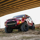 Low-angle photo showing the C4 High Clearance Additions and the tire clearance they provide for 2014+ Toyota 4Runners.