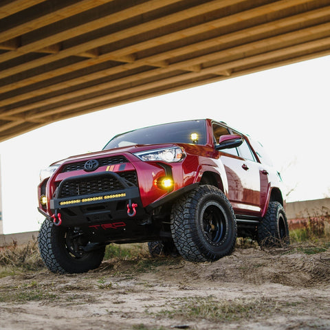 Low-angle photo showing the C4 High Clearance Additions and the tire clearance they provide for 2014+ Toyota 4Runners.